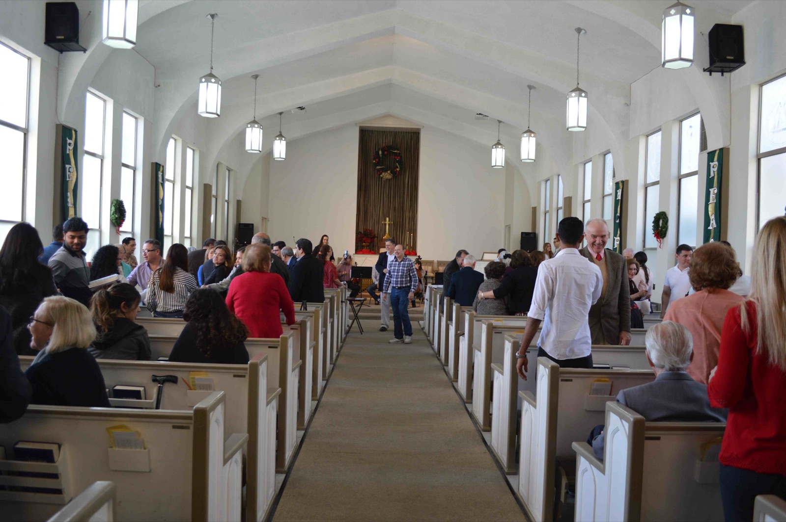 The congregation greeting one another in the sanctuary